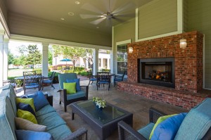 One Bedroom Apartments for Rent in Conroe, TX - Covered Outdoor Seating Area with lit Fireplace   